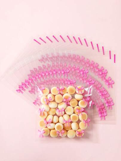 100 pièces Cachets cadeaux roses à nœud, auto-scellants, sachets à bonbons d'anniversaire, sachets pour biscuits, décorations pour fête d'anniversaire de fille, emballages cadeaux sur le thème des nœuds, décorations de mariage, décorations pour baby shower, décorations pour enterrement de vie de jeune fille, décorations pour révélation du sexe du bébé, articles de fête roses, décorations de table pour enterrement de vie de jeune fille, fournitures d'emballage pour la cuisine, décoration de chambre, décoration intérieure, décorations à nœud rose, cadeaux d'anniversaire, petits cadeaux pour invités