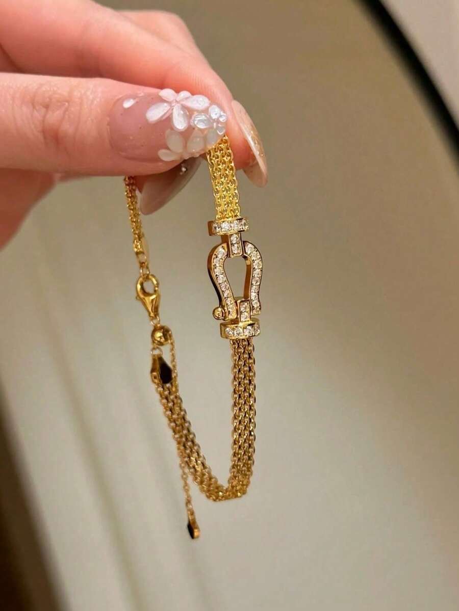 1条米兰尼西马蹄形扣编织手链，镀金镂空表带，时尚简约百搭设计