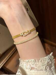 1条米兰尼西马蹄形扣编织手链，镀金镂空表带，时尚简约百搭设计