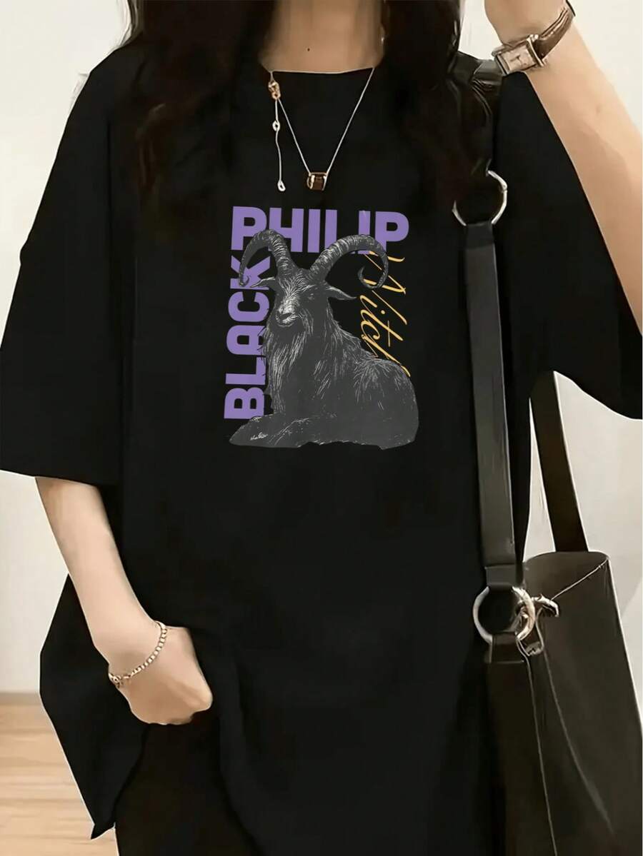 This Is A Black Short-Sleeve T-Shirt With A Loose Fit, Providing Comfort And Ease. The Front Features Designs And Text Related To 'BLACK PHILIP', Including An Image Of A Goat. The Overall Design Has A Dark And Fantastical Style - màu đen - Xem 1