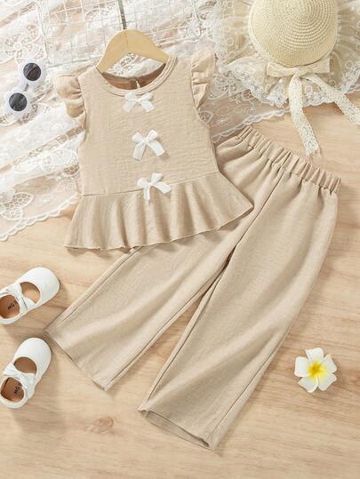两件套女童夏季新款蝴蝶结装饰纯色简约荷叶袖荷叶边下摆上衣+休闲直筒裤套装，适合海滩度假