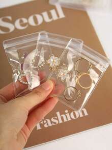 160 sztuk przezroczystych torebek do przechowywania biżuterii, odpowiednich do naszyjników, bransoletek i pierścionków. Mogą służyć jako stojak na biżuterię w szufladzie biurkowej. Wykonane z tworzywa sztucznego odpornego na utlenianie. Idealne do przechowywania biżuterii. Idealne również na imprezy z okazji ujawnienia płci dziecka, urodziny, wesela i spotkania towarzyskie. Idealny prezent dla współpracowników, przyjaciół i rodziny. Idealny wybór na powrót do szkoły. - Wielokolorowe - Zobacz 6