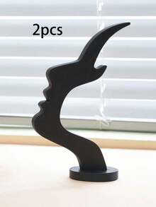 1个侧脸造型眼镜架，独特的弧形设计，塑料材质，兼具艺术收纳功能，可提升桌面或床头柜的装饰格调，简约实用的黑色设计，节日/圣诞礼物之选。