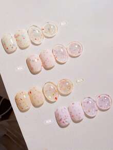 15毫升容量，2026秋冬圣诞季新款女士圣诞礼盒套装，包含流行的甜酸奶冰淇淋糖片、波点、彩色大小亮片、贝壳玻璃纸凝胶指甲油，适合四季美甲。搭配底油和封层使用，需配合UV灯使用。 - 彩色 - 查看 9