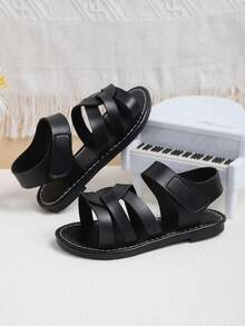 1双黑色防滑厚底优质PU皮鞋面交叉旋转设计时尚儿童平底凉鞋，复古简约风格魔术贴搭扣，适合搭配公主裙和连衣裙，男女童均适用，适合3-16岁学生日常穿着，生日派对、假期、海滩等场合，2026春夏新款。 - 黑色 - 查看 7