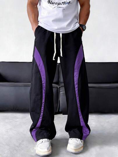 男士四季速干运动裤，紫色弧形拼接设计，配有抽绳口袋，宽松舒适，适合跑步、健身和日常穿着。