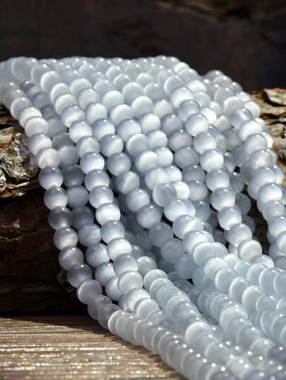 4/6/8/10毫米猫眼圆珠，白色珠光石材质，适合DIY手链、项链及其他珠宝制作，是珠宝爱好者的理想手工材料。