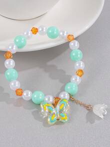 1 pulsera de niña con cuentas y dijes de mariposa y lirio del valle - Multicolor - Ver 9