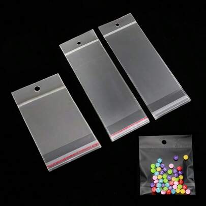 50 piezas Bolsas transparentes autosellantes, bolsas de almacenamiento de plástico OPP con agujeros para colgar, adecuadas para joyería, exhibición minorista, regalos, embalaje de fiestas