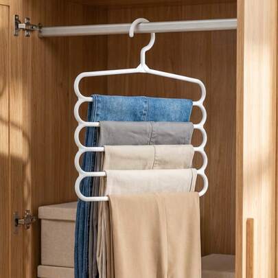 One White Multi-Layer Trouser Rack, A Space-Saving Wardrobe Storage Rack That Allows For The Categorization And Quick Selection Of Different Styles Of Trousers.