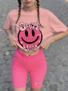 Bộ đồ 2 món cho bé gái với họa tiết mặt cười, áo thun hồng graffiti hình mặt cười và quần short biker, phong cách đường phố Y2K mùa hè, thích hợp cho hoạt động trượt ván và đi chơi. - Hồng - Xem 1