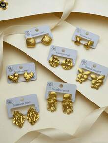 7 Pairs Of Elegant And Luxurious Golden Women's Earrings - 18K Gold Plated, Made Of Stainless Steel, Hypoallergenic. Simple And Mosaic-Free Design, Double Bow Style, Heart-Shaped, Romantic. Round Uneven Design. Perfect For Daily And Festive Wear. Hearts Valentines Jewelry - Multicolor - View 6