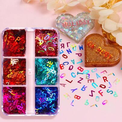 一盒全息字母环氧树脂亮片，包含闪亮的金色和银色大写字母形状，非常适合用于工艺品和珠宝制作。
