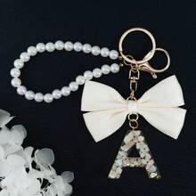 Móc khóa chữ cái đầu dễ thương màu trắng, móc khóa chữ cái in hoa bằng nhựa mạ vàng với mặt dây chuyền hình bướm tua rua, móc khóa thời trang dành cho nữ, quà tặng trang trí ví, túi xách, quà tặng Ngày của Cha, Ngày của Mẹ, sinh nhật, Lễ Tạ ơn và Giáng sinh, quà tặng ngày lễ cho mẹ, cha, tốt nghiệp và giáo viên. - nơ - Xem 18