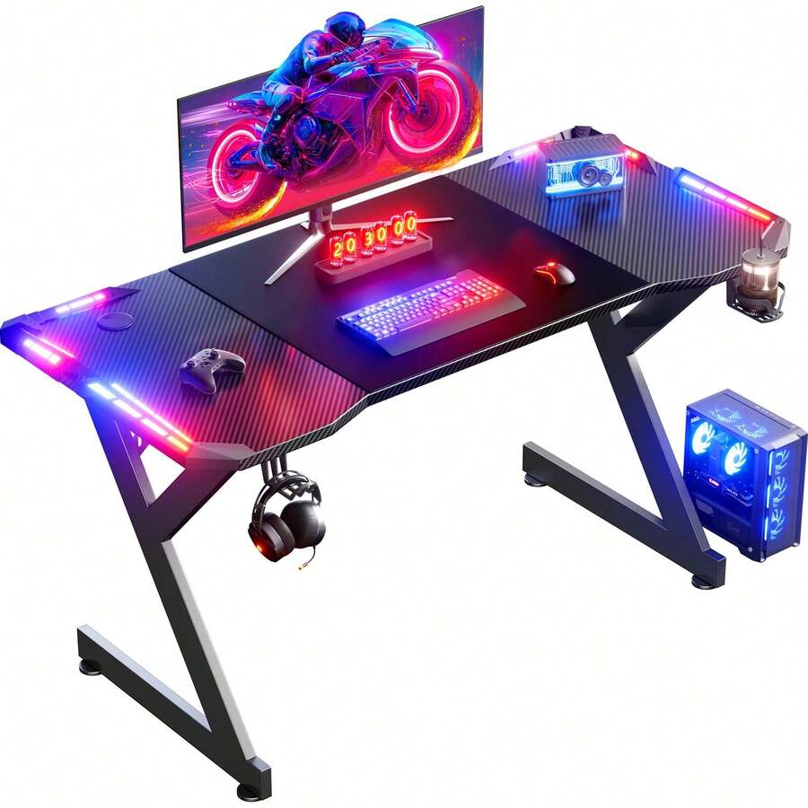 HLDIRECT Gaming Desk With LED Lights, Ergonomic Computer Gaming Table With Carbon Fibre Surface, Sturdy PC Workstation Desk For Gaming And Home Office With Headphone Hook, Cup Holder, Black