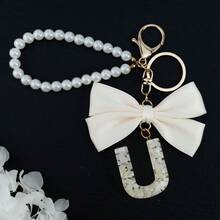 Móc khóa chữ cái đầu dễ thương màu trắng, móc khóa chữ cái in hoa bằng nhựa mạ vàng với mặt dây chuyền hình bướm tua rua, móc khóa thời trang dành cho nữ, quà tặng trang trí ví, túi xách, quà tặng Ngày của Cha, Ngày của Mẹ, sinh nhật, Lễ Tạ ơn và Giáng sinh, quà tặng ngày lễ cho mẹ, cha, tốt nghiệp và giáo viên. - nơ - Xem 32