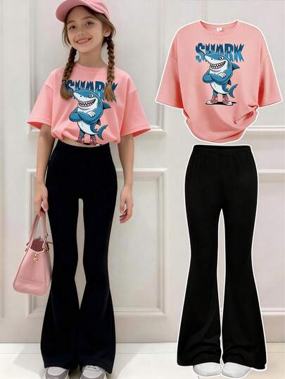 This Casual Outfit Features A Unique Cartoon Shark Print Design And Includes A Pink Short-Sleeved Crew Neck T-Shirt And A Pair Of Black Flared Pants