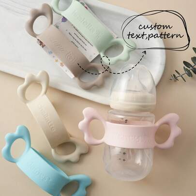 1pc Personalized Customization Debossed Name And Pattern Wings Silicone Baby Bottle Cover Lightweight Baby Bottle Handle Grip Sleeve With Partial Protection, Anti-Slip Design For Bottles And Water Cups Childern Essentials Gifts