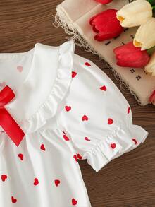 Bộ áo liền quần cho bé gái dễ thương, tay bồng, cổ áo có nơ và họa tiết trái tim, cài khuy ở đáy quần, trang phục thường ngày thời trang và đa năng, phù hợp cho các hoạt động hàng ngày, dự tiệc, đi chơi, mùa xuân/hè. - trắng - Xem 5