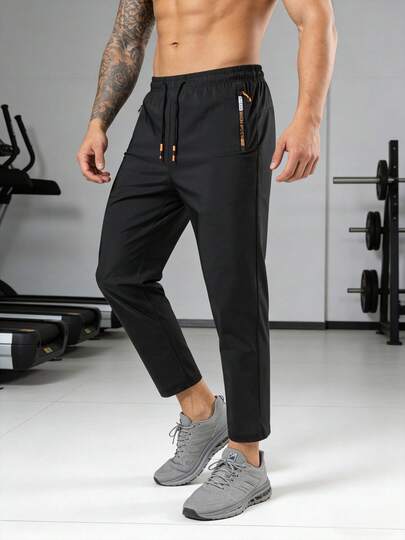 男士速干运动裤，透气面料，抽绳腰带，侧拉链口袋，轻便吸湿排汗，直筒裤型，适合夏季健身、跑步、户外休闲等活动。