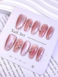 10片中号椭圆形假指甲，柔和的粉色珠光色调，3D裂纹纹理，点缀水钻，打造温柔梦幻的风格。100%纯手工制作，按压式亚克力指甲，可重复使用。套装包含1片果冻胶、1根胶棒和1把指甲锉，适合女性日常或派对佩戴。 - 彩色 - 查看 4