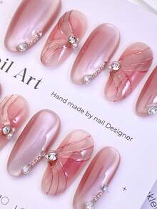 10片中号椭圆形假指甲，柔和的粉色珠光色调，3D裂纹纹理，点缀水钻，打造温柔梦幻的风格。100%纯手工制作，按压式亚克力指甲，可重复使用。套装包含1片果冻胶、1根胶棒和1把指甲锉，适合女性日常或派对佩戴。 - 彩色 - 查看 3