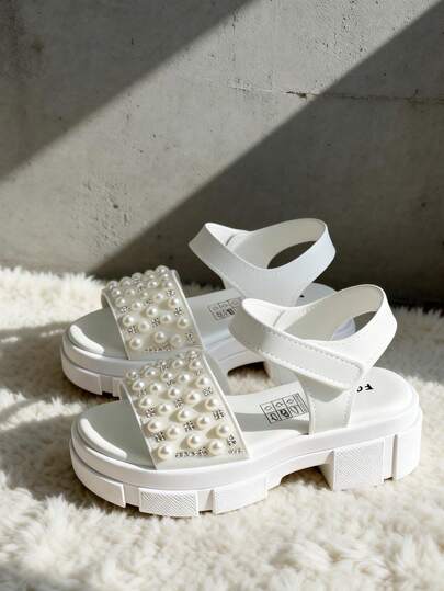 Nieuwe kinderschoenen 2026 - Meisjessandalen! Witte sandalen met dikke zool voor meisjes van 8-15 jaar, versierd met parelstrasssteentjes en een klittenbandsluiting. De dikke zool zorgt voor schokabsorptie en laat de benen langer lijken. Geschikt voor school, uitjes en afspraakjes. Schattige en elegante hoge sandalen die er niet kinderachtig uitzien.