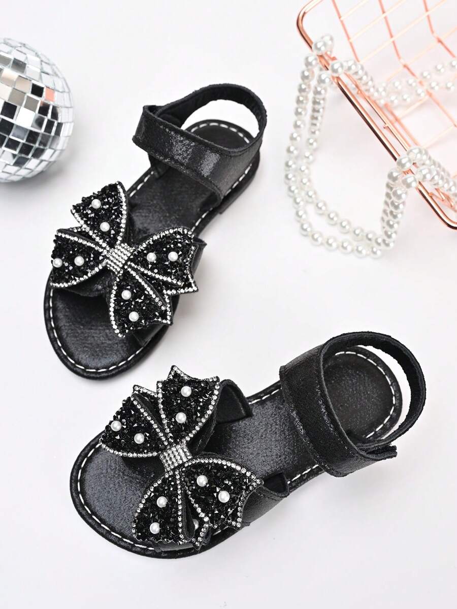 Sandal đế bằng chống trượt đính sequin và nơ bóng bẩy mới năm 2026 dành cho bé gái, thích hợp cho các chuyến đi chơi cuối tuần cùng gia đình, tiệc trà của chị em gái, các hoạt động ở trường mẫu giáo. - màu đen - Xem 1