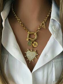 1件女士金项链，采用光滑的马蹄形扣设计，搭配字母、三角形和心形吊坠，设计细节丰富，时尚休闲，可搭配白衬衫。 - 金色 - 查看 14