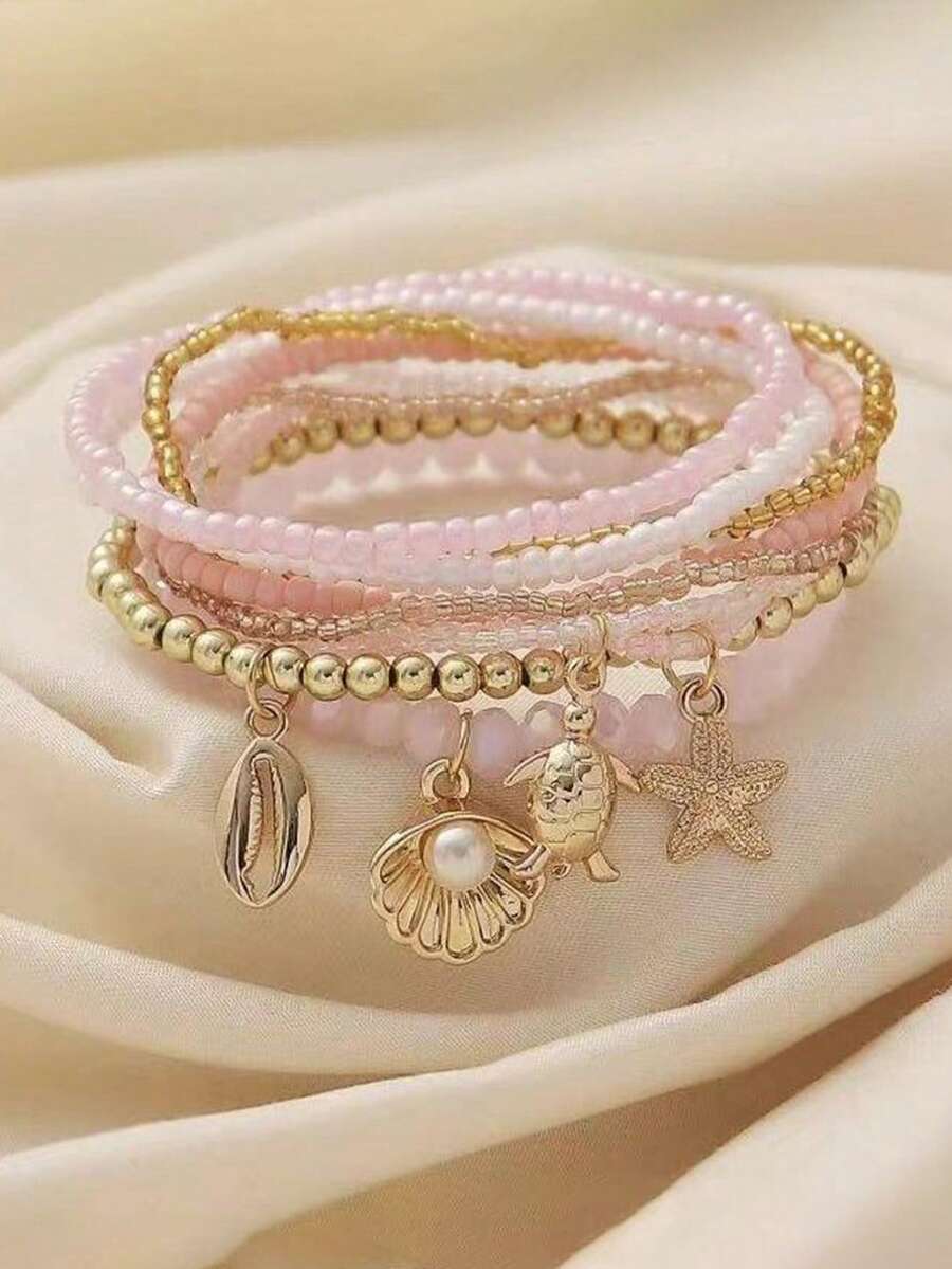 Bộ 9 vòng tay hạt thủy tinh hình cá heo phong cách kỳ nghỉ biển, thiết kế vỏ sò sóng biển tinh tế, phù hợp cho bé gái, trang phục thường ngày khi đi biển, món quà ý nghĩa. - Hồng - Xem 1