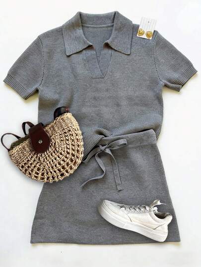 女士优雅休闲度假风灰色针织上衣和半身裙两件套，包括V领短袖修身针织上衣（前襟半开襟），搭配修身半身裙。适合度假或居家休闲穿着。