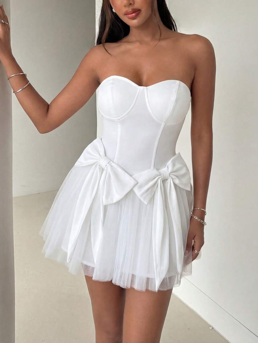 优雅白色无肩带修身迷你连衣裙，胸部饰有缝线和拉链细节，腰部两侧点缀大蝴蝶结，蓬松轻盈的薄纱裙摆——甜美性感又不失时尚感，是生日派对、约会之夜、周末花园派对、城市公园漫步的理想之选。 - 白色 - 查看 1