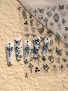 1张哥特复古主题美甲贴纸，精致神秘风格，包含天使、十字架、蝴蝶、心形、月亮、花朵、复古边框、藤蔓、细线条等元素，充满暗黑神秘的美感，适合DIY美甲和装饰，尤其适合喜欢暗黑、哥特、复古小众风格美甲的人士。 - 黑色 - 查看 3