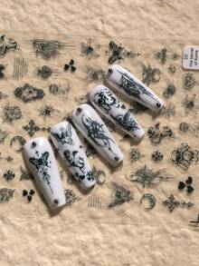 1张哥特复古主题美甲贴纸，精致神秘风格，包含天使、十字架、蝴蝶、心形、月亮、花朵、复古边框、藤蔓、细线条等元素，充满暗黑神秘的美感，适合DIY美甲和装饰，尤其适合喜欢暗黑、哥特、复古小众风格美甲的人士。 - 黑色 - 查看 4