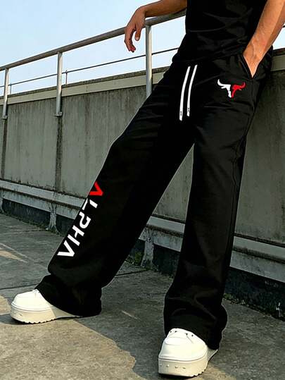 Pantalones anchos de hombre en color negro con cordón de color contrastante y estampado de letras, adelgazantes y versátiles para uso diario, ir al trabajo y fines de semana