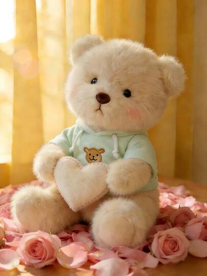 这款9.84英寸超柔软米色泰迪熊毛绒玩具，采用如云般柔软舒适的面料制成。它穿着浅绿色连帽衫，上面绣有可爱的熊图案，黑色圆眼睛和粉色腮红更添魅力。