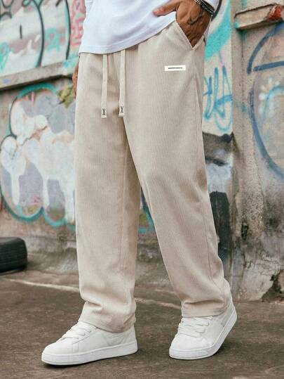 Pantalones casuales rectos y sueltos de pana de unicolor para hombres, con cintura con cordón, pierna ancha, diseño de etiqueta con letra simple, adecuados para el viaje diario, salida casual, cita nocturna, excursión al aire libre, deportes de verano