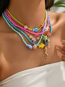 1件优雅可爱的波西米亚海洋元素陶瓷鱼、海星、金海螺、金贝壳、五彩种子珠、水钻、金鱼、橙色/黄色/绿色/红色等。多款可选女士多层串珠项链，海滩派对项链，精致欧式风格，适合日常佩戴，毕业/返校礼物。实际混合种子珠颜色可能与官方照片有所不同，这是由于高温陶瓷绘画工艺和轻微瑕疵造成的正常现象。 - 彩色 - 查看 5