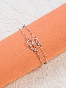 Un brazalete con forma de corazón entrelazado con diamantes de moda y un brazalete elegante - forma de corazón - Ver 2