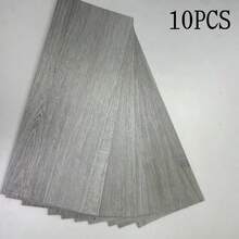 10片装，每片尺寸40x15厘米/15.75x5.91英寸，面积0.6平方米，可移除木纹地板贴纸，PVC材质，木纹自粘瓷砖贴纸，易于安装，防水防刮，适用于卧室、厨房、客厅、酒店等场所的家具和地板装饰。 - 10Pcs - 查看 13
