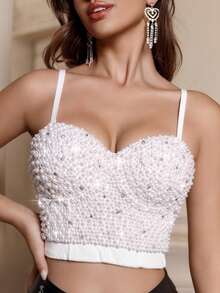 春夏优雅珍珠装饰露背吊带短款上衣，饰以水钻，配有可调节肩带和衬垫罩杯，采用略带弹性的涤纶面料，露背设计，适合情人节、狂欢节、派对、夜店、周年纪念、音乐会、单身派对、节日正式场合穿着，尽显奢华，是派对亮点，性感又不失精致。 - 白色 - 查看 1