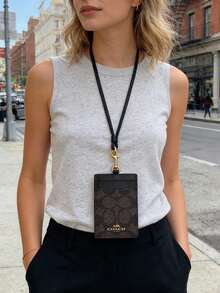 Coach Portaidentificación de cuero con ventana transparente para identificación, ranuras para tarjetas de crédito y correa para el cuello desmontable - Color nogal y negro - Ver 2