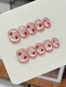 10片纯手工制作的按压式美甲贴片，短款椭圆形美甲贴片，粉色美甲贴片，可爱甜美的心形裸粉色猫眼图案，饰有3D红色爱心，手绘波点，简约柔和的按压式美甲贴片，适合女性和女孩，春夏秋冬节日派对和日常生活使用。 - 粉色 - 查看 1