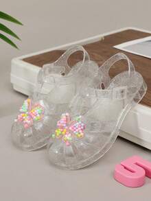 Giày sandal cầu vồng khoét lỗ mới năm 2026, giày công chúa pha lê cho bé gái, kiểu dáng retro dễ thương đa năng, sandal nhựa lấp lánh thời trang mùa hè cho học sinh. - trắng - Xem 1