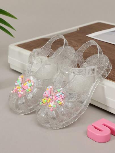 Giày sandal cầu vồng khoét lỗ mới năm 2026, giày công chúa pha lê cho bé gái, kiểu dáng retro dễ thương đa năng, sandal nhựa lấp lánh thời trang mùa hè cho học sinh.