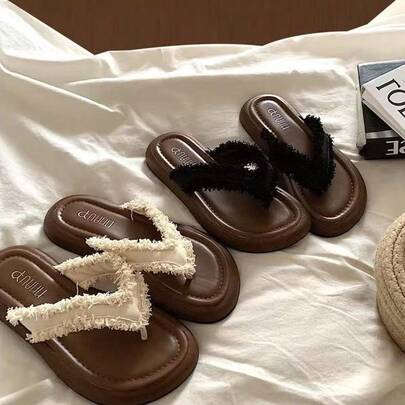 女士夏季平底露趾凉鞋，采用柔软的PU材质和布料拼接而成，并饰有流苏细节。鞋面饰有蕾丝花边和装饰元素，搭配橡胶外底，穿着舒适贴合。适合海滩度假、户外活动、休闲穿着、鸡尾酒会和日常户外场合。棕色沙滩风露趾凉鞋。