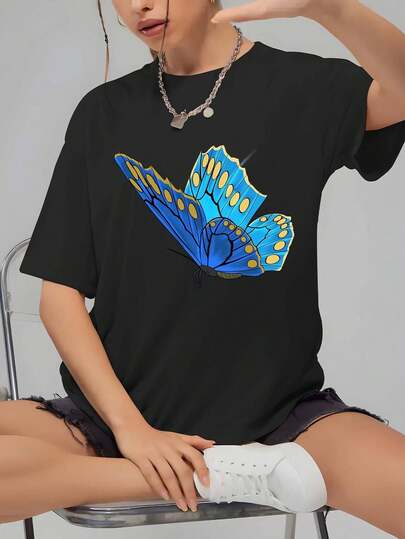 Camiseta oversize de mujer, estampado único de mariposa azul con lunares dorados, manga corta de diseño, cómoda y versátil para un look fresco y casual.