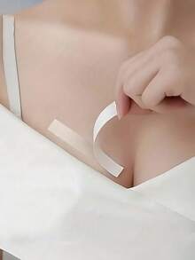 防走光乳贴、隐形防滑贴、女士时尚胶带、防滑服装胶带、连衣裙肩带固定器、无缝双面防水透明贴纸、双面衣橱胶带、返校及派对服装应急包，所有产品均旨在防止走光并牢固固定您的服装。 - A - 查看 6