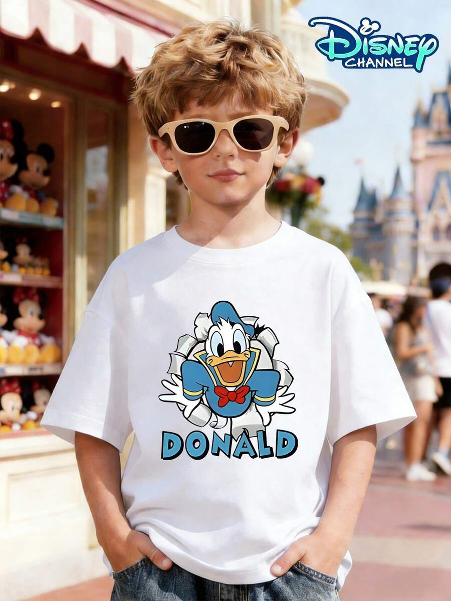 This White Short-Sleeved T-Shirt For Boys Aged 3-12 Features A Cartoon Print Of Donald Duck Bursting Through A Wall On The Front, Dressed In A Blue Sailor Suit And Red Bow Tie, With A Lively Expression. The Word "DONALD" Is Displayed In Blue Artistic Lettering Below. The Back Features A Print Of Donald Duck's Back, Showing His White Tail, Yellow Feet, And The Wall-Breaking Effect. It Can Be Paired With Wide-Leg Jeans, Cargo Shorts, Casual Sweatpants, And Athletic Joggers, Making It Suitable For Various Occasions Such As Disneyland Visits, Family Outings, Daily School Days, Outdoor Gatherings, And Themed Parties. It Precisely Matches The Trending Search Demand For Family Outings And Cartoon Merchandise On The US Marketplace, Satisfying Both Boys' Everyday Wear And Themed Event Needs. - White - View 1