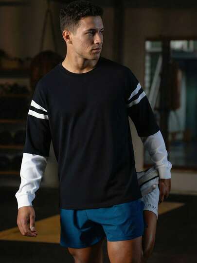 男士宽松仿两件式圆领长袖T恤，适合户外运动、健身房锻炼和休闲穿着，春夏黑色